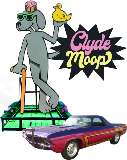 Clyde Moop statue - Cartoon dog with a cupcake on his head, holding a yellow duck, wearing sunglasses, with a cane, from Detroit, Michigan